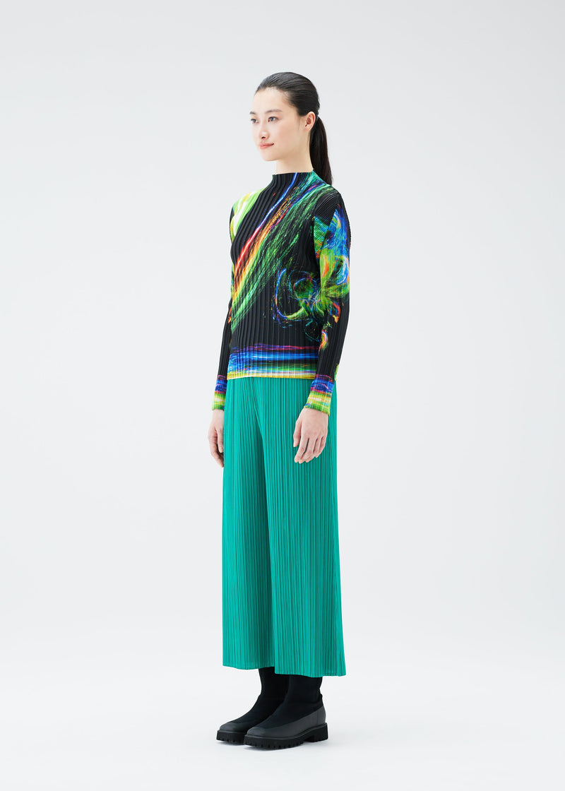 A model wears the PLEATS PLEASE ISSEY MIYAKE SPECTRUM RIB top.