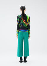 A model wears the PLEATS PLEASE ISSEY MIYAKE SPECTRUM RIB top.