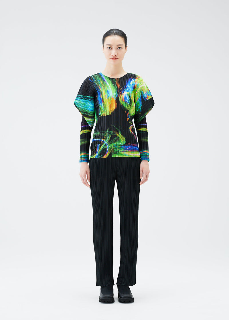 A model wears the PLEATS PLEASE ISSEY MIYAKE SPECTRUM RIB top.