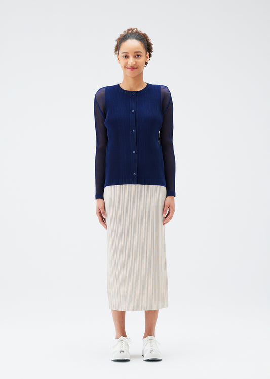 A model wears the PLEATS PLEASE ISSEY MIYAKE  TATAMI JULY cardigan