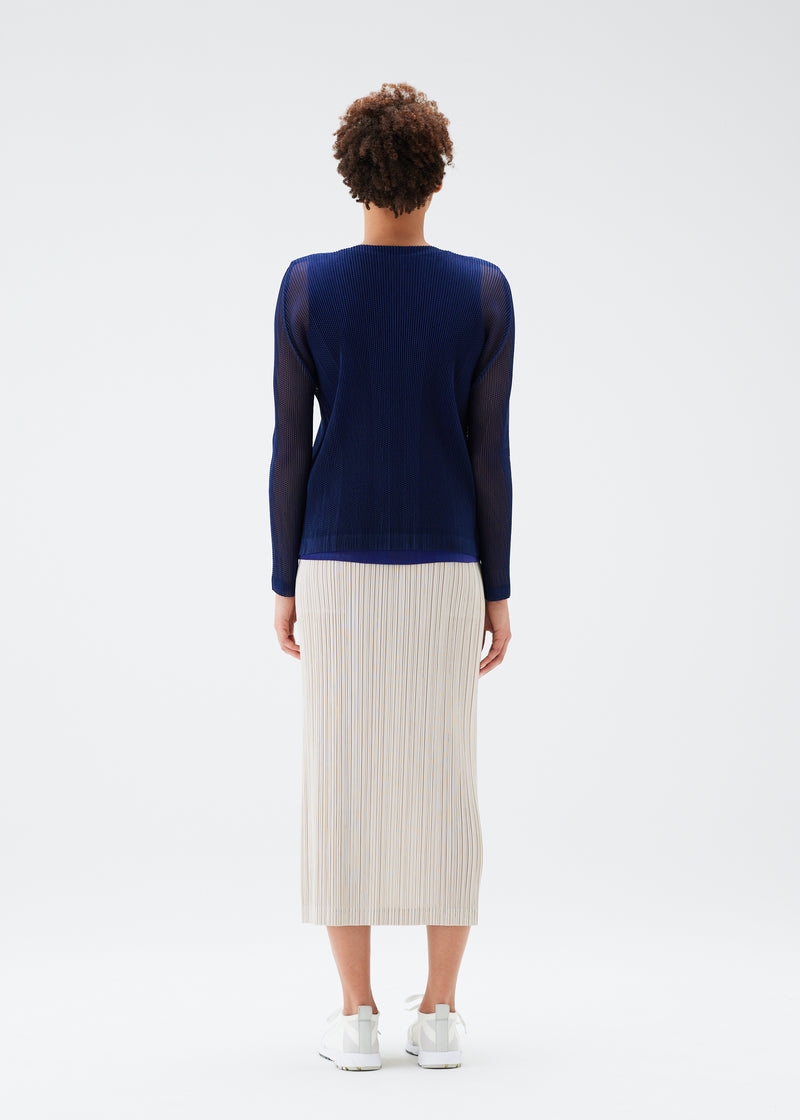 A model wears the PLEATS PLEASE ISSEY MIYAKE  TATAMI JULY cardigan