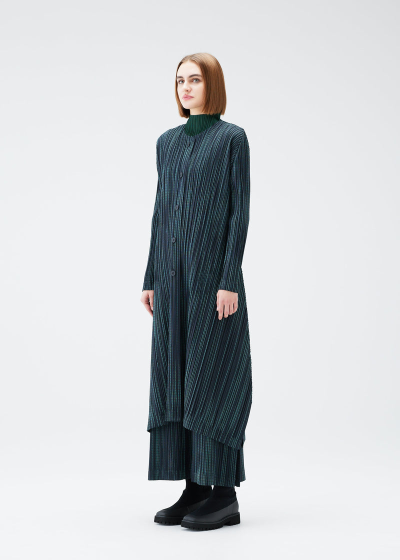 A model wears the PLEATS PLEASE ISSEY MIYAKE METEOR SHOWER coat.