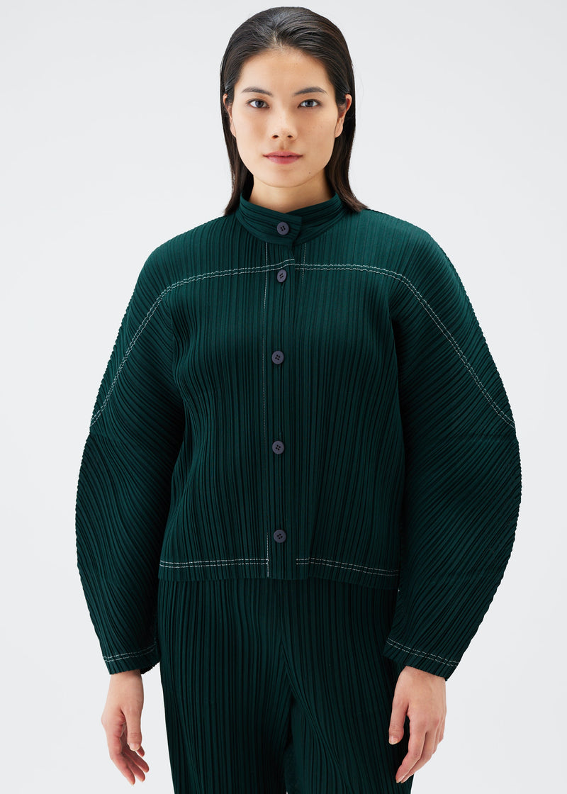 A model wears the PLEATS PLEASE ISSEY MIYAKE RAMIE PLEATS jacket.