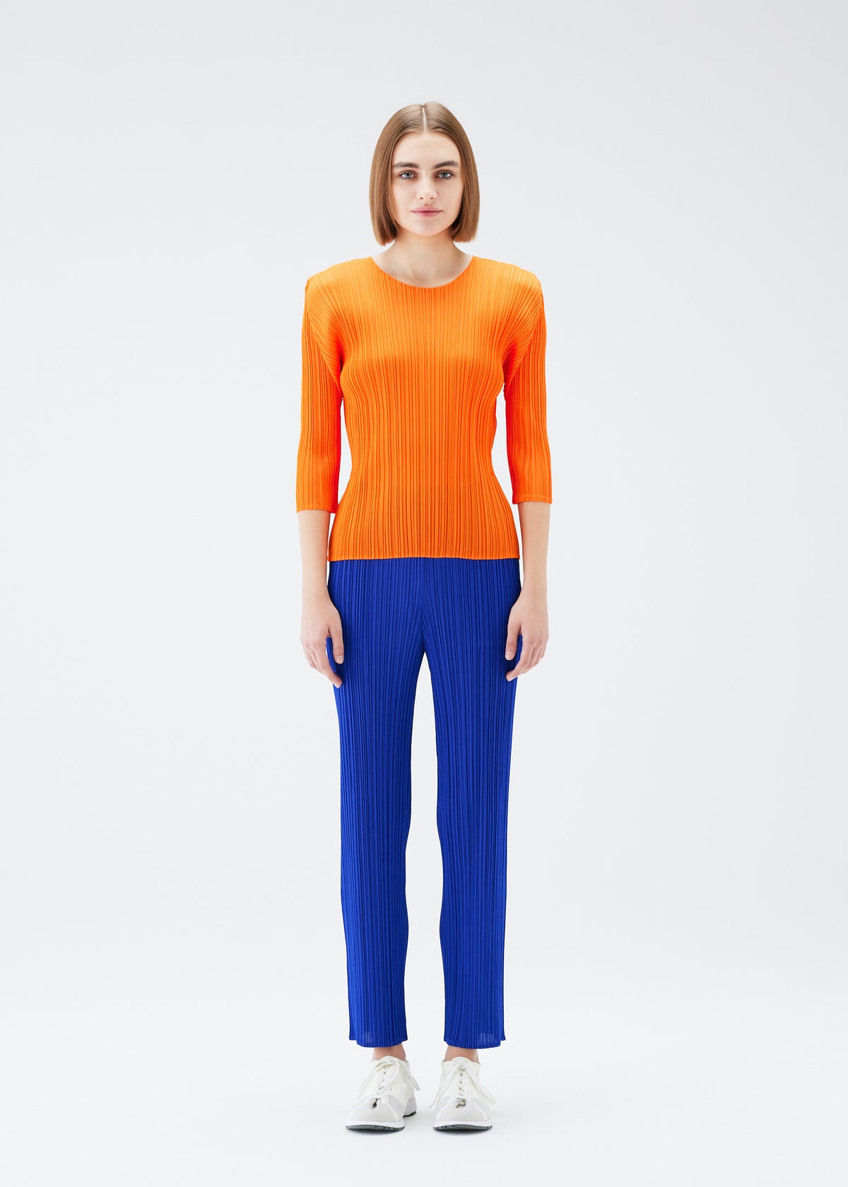 A model wears the PLEATS PLEASE ISSEY MIYAKE  MONTHLY COLORS JULY trousers