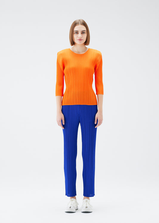 A model wears the PLEATS PLEASE ISSEY MIYAKE  MONTHLY COLORS JULY trousers