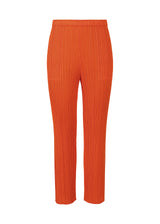 A product shot of the PLEATS PLEASE ISSEY MIYAKE  MONTHLY COLORS JULY trousers in dark orange (33)