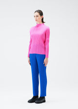 A model wears the PLEATS PLEASE ISSEY MIYAKE MONTHLY COLORS OCTOBER trousers.