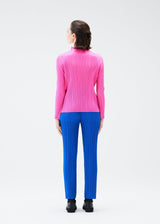 A model wears the PLEATS PLEASE ISSEY MIYAKE MONTHLY COLORS OCTOBER trousers.