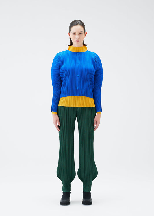 A model wears the PLEATS PLEASE ISSEY MIYAKE MONTHLY COLORS OCTOBER trousers.