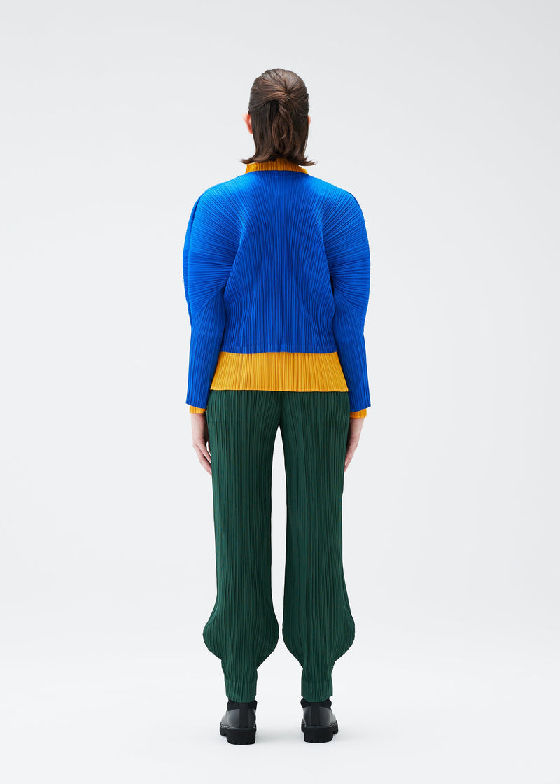 A model wears the PLEATS PLEASE ISSEY MIYAKE MONTHLY COLORS OCTOBER trousers.