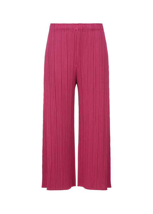 A product shot of the PLEATS PLEASE ISSEY MIYAKE MONTHLY COLORS NOVEMBER trousers in magenta (83).