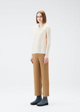 A model wears the PLEATS PLEASE ISSEY MIYAKE MONTHLY COLORS DECEMBER trousers.