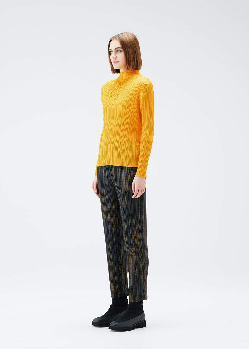 A model wears the PLEATS PLEASE ISSEY MIYAKE METEOR SHOWER trousers.