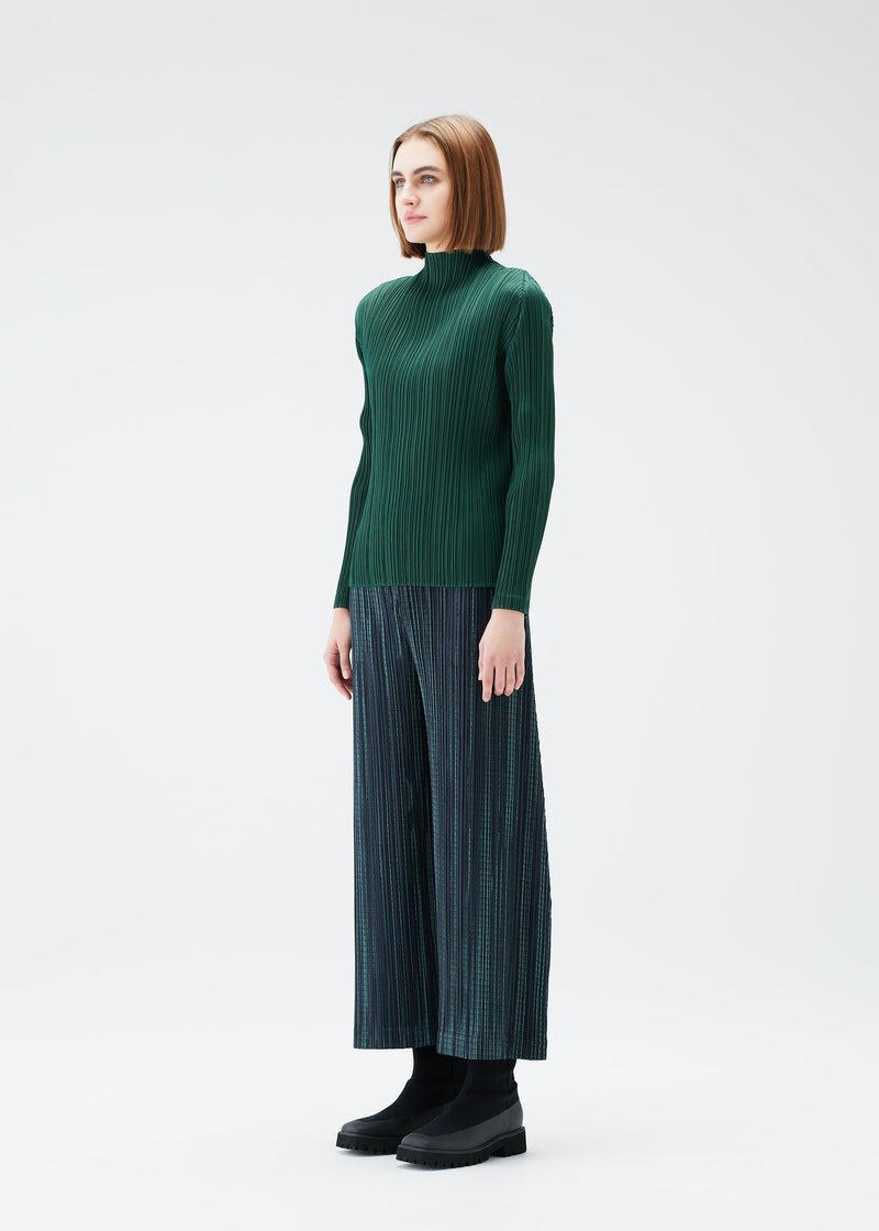 A model wears the PLEATS PLEASE ISSEY MIYAKE METEOR SHOWER trousers.