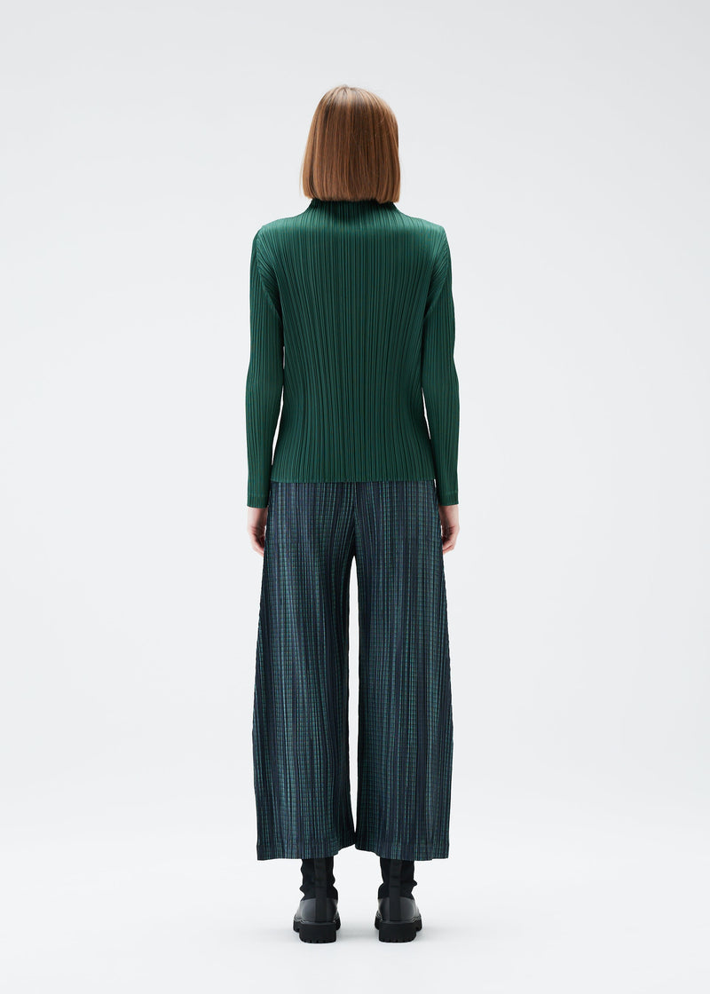 A model wears the PLEATS PLEASE ISSEY MIYAKE METEOR SHOWER trousers.