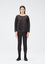 A model wears the PLEATS PLEASE ISSEY MIYAKE UFO trousers.