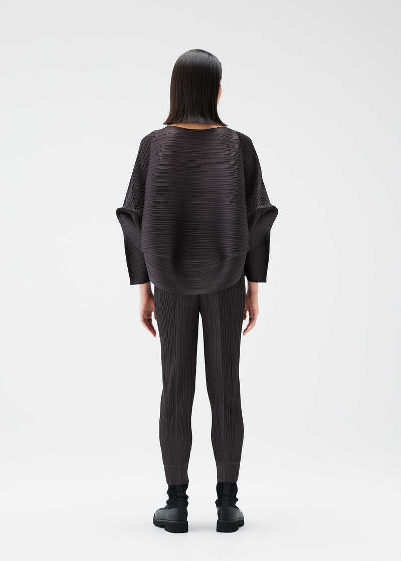 A model wears the PLEATS PLEASE ISSEY MIYAKE UFO trousers.