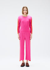 A model wears the PLEATS PLEASE ISSEY MIYAKE  COMET trousers