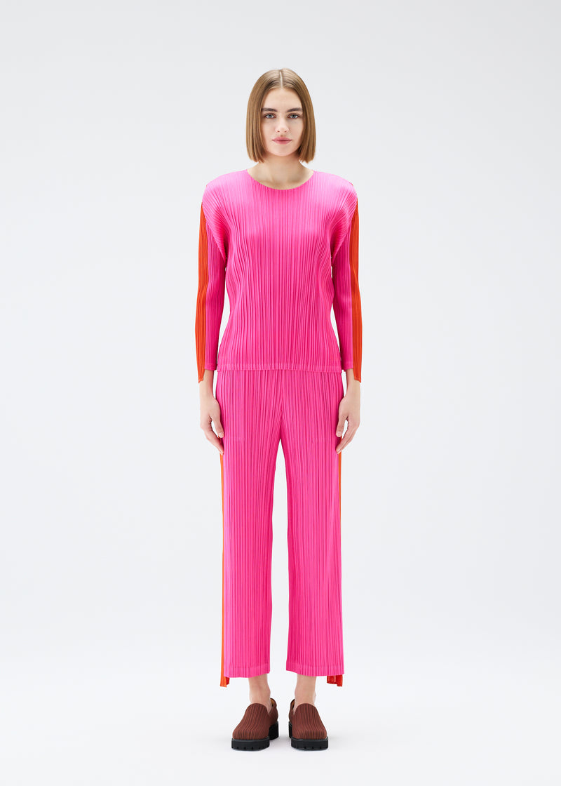 A model wears the PLEATS PLEASE ISSEY MIYAKE  COMET trousers