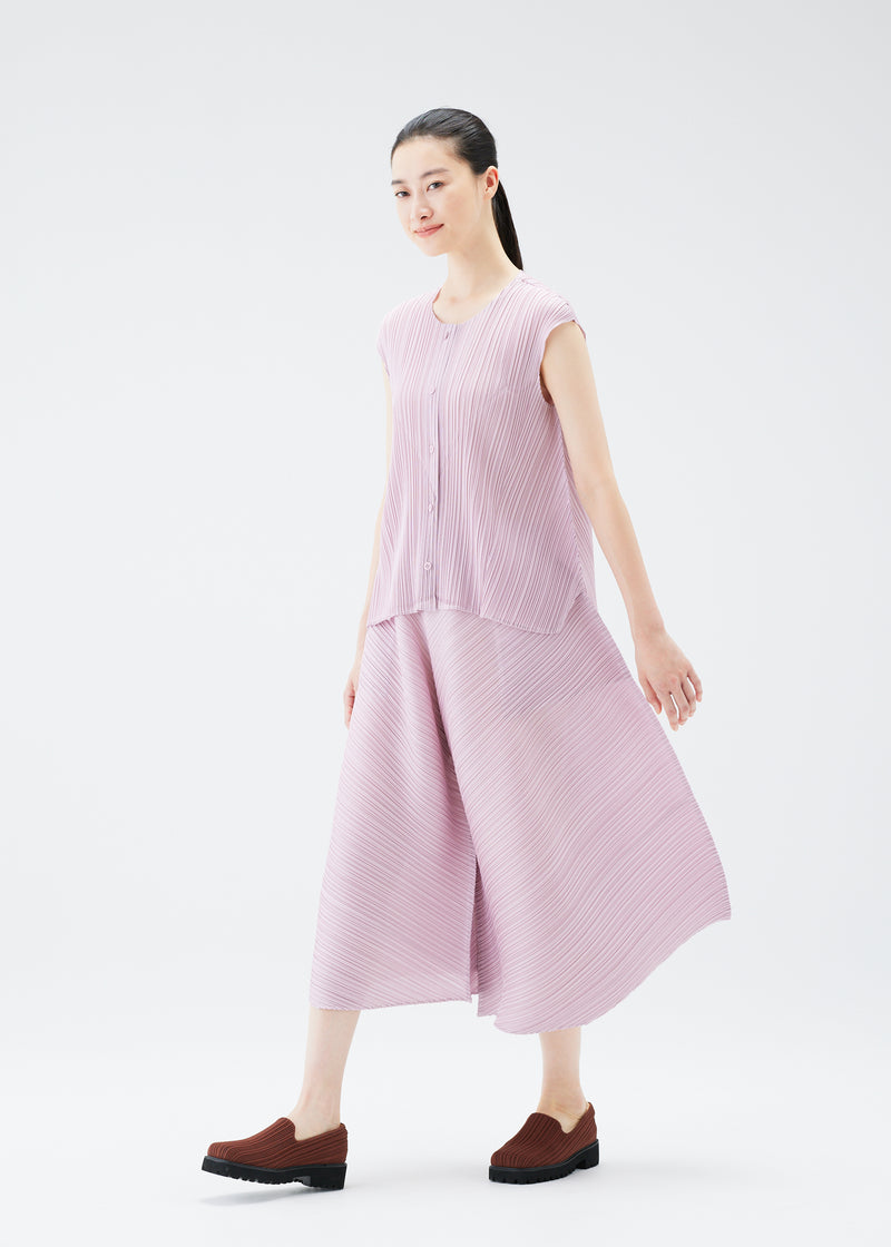 A model wears the PLEATS PLEASE ISSEY MIYAKE  SOLAR FLARE trousers