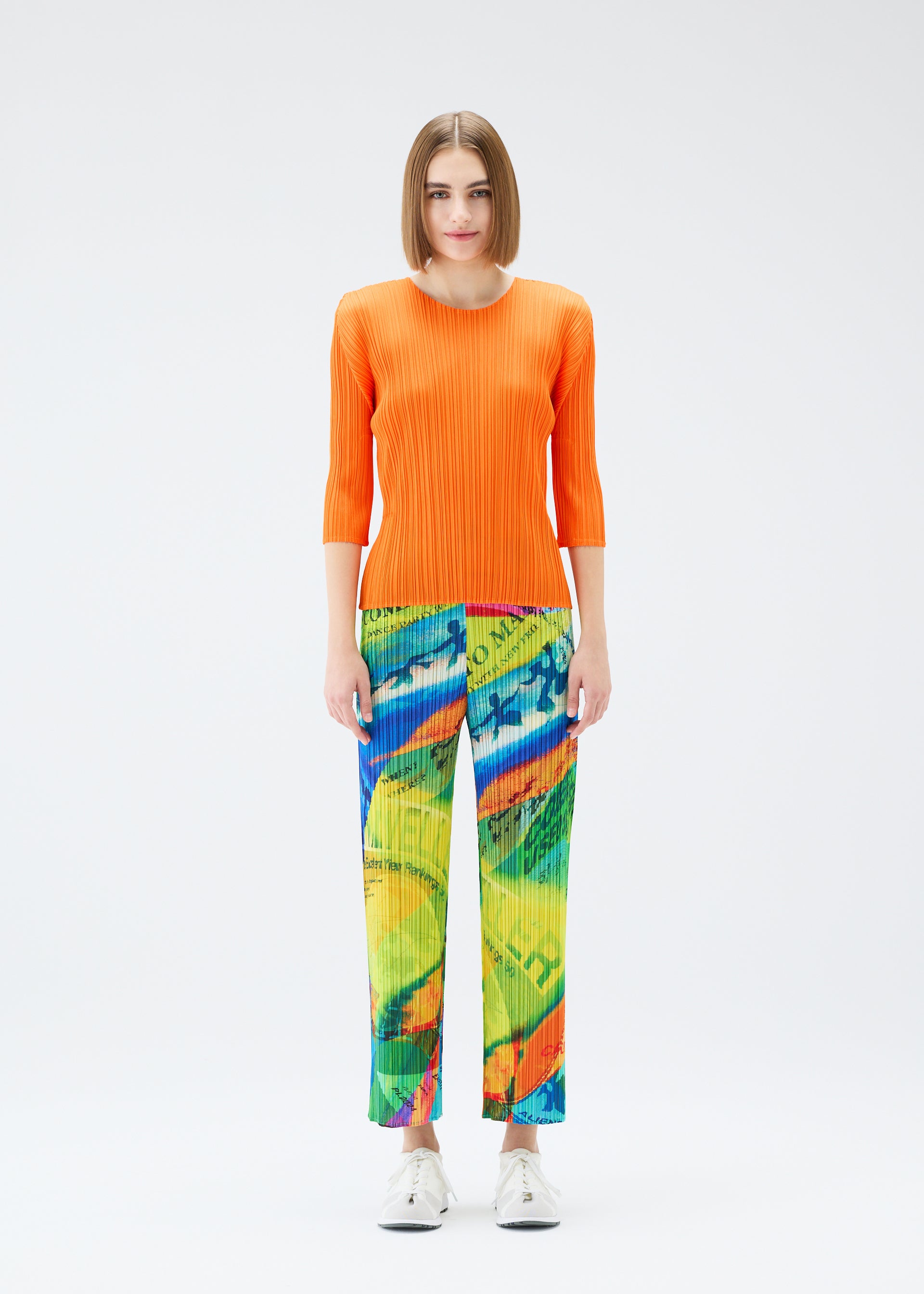 A model wears the PLEATS PLEASE ISSEY MIYAKE  VOYAGER trousers