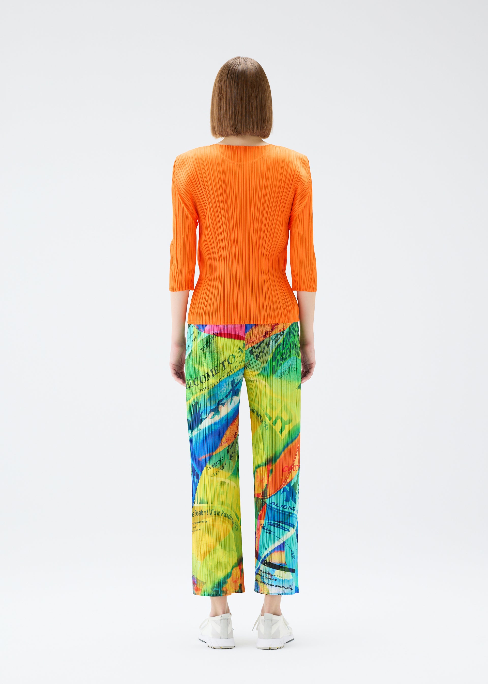 A model wears the PLEATS PLEASE ISSEY MIYAKE  VOYAGER trousers