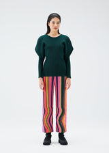 A model wears the PLEATS PLEASE ISSEY MIYAKE WARP trousers.