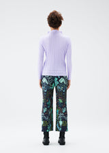 A model wears the PLEATS PLEASE ISSEY MIYAKE INTERPLANETARY trousers.