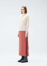 A model wears the PLEATS PLEASE ISSEY MIYAKE MONTHLY COLORS DECEMBER skirt.