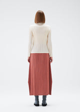 A model wears the PLEATS PLEASE ISSEY MIYAKE MONTHLY COLORS DECEMBER skirt.