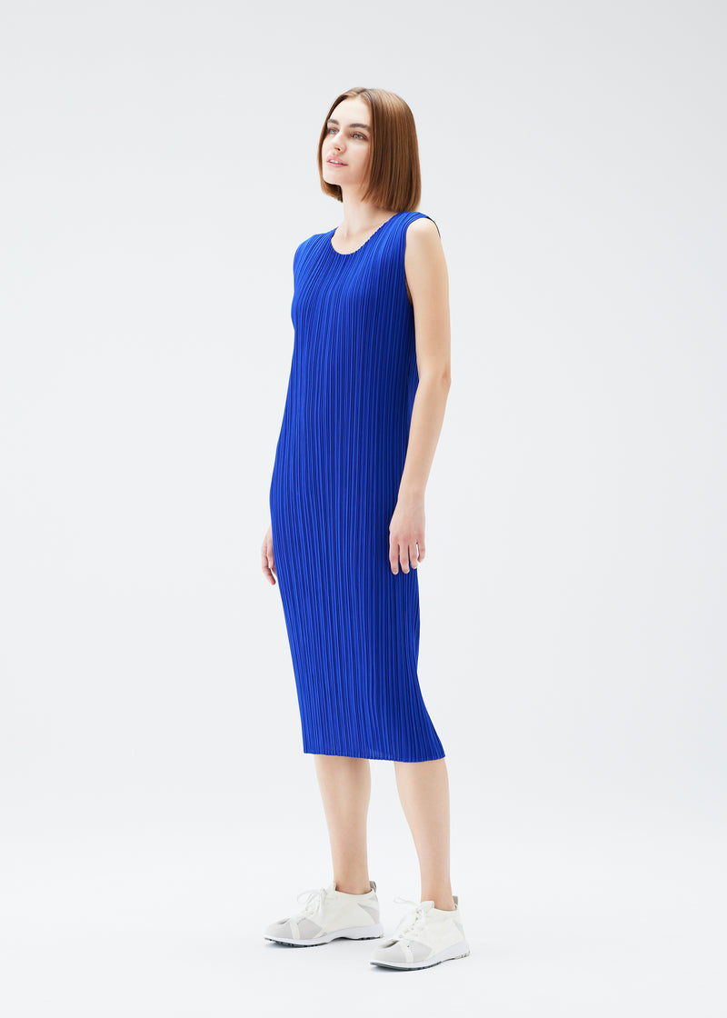 A model wears the PLEATS PLEASE ISSEY MIYAKE  MONTHLY COLORS JULY dress