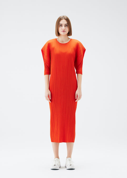 A model wears the PLEATS PLEASE ISSEY MIYAKE  MONTHLY COLORS JULY dress