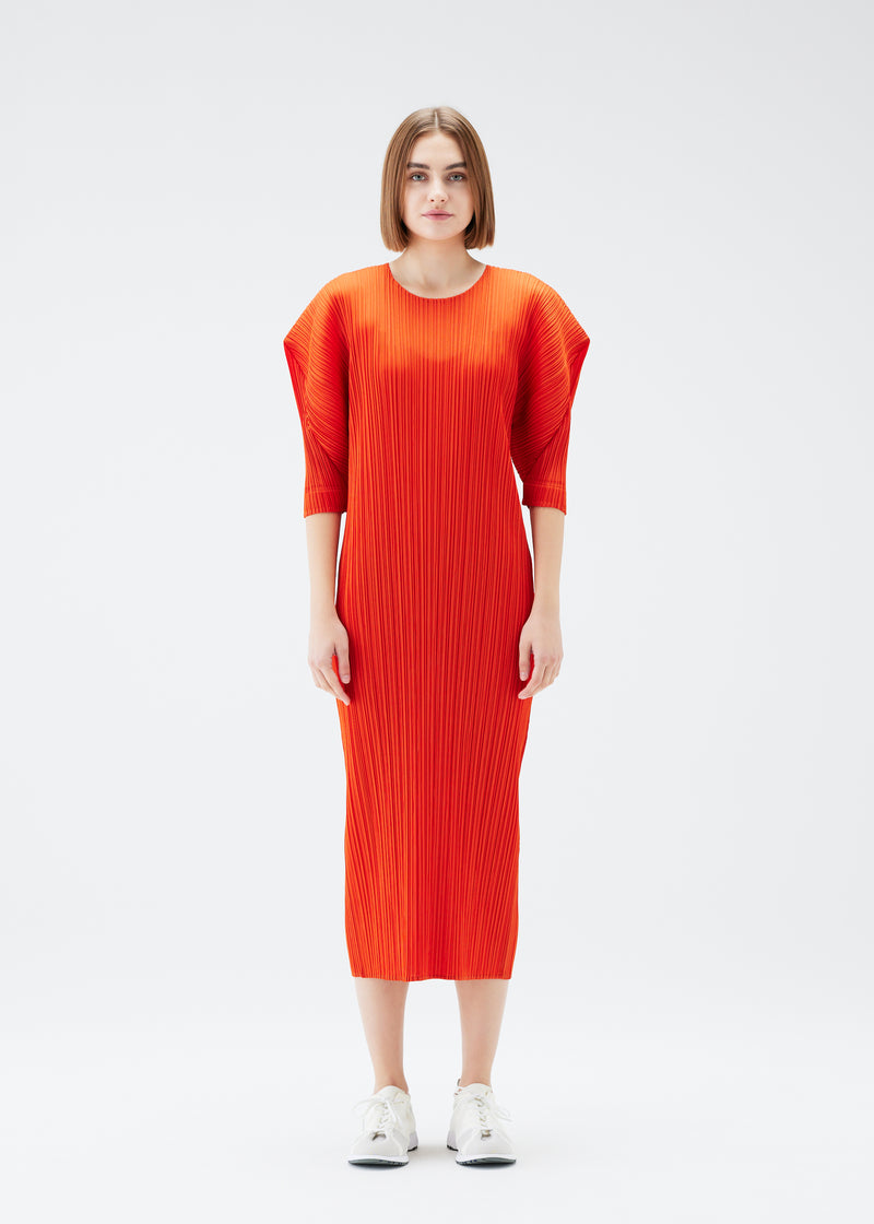 A model wears the PLEATS PLEASE ISSEY MIYAKE  MONTHLY COLORS JULY dress