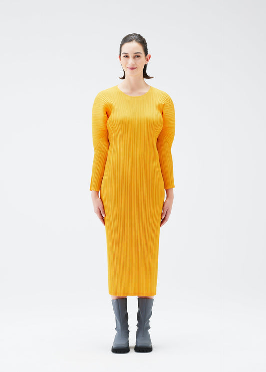 A model wears the PLEATS PLEASE ISSEY MIYAKE MONTHLY COLORS OCTOBER dress.