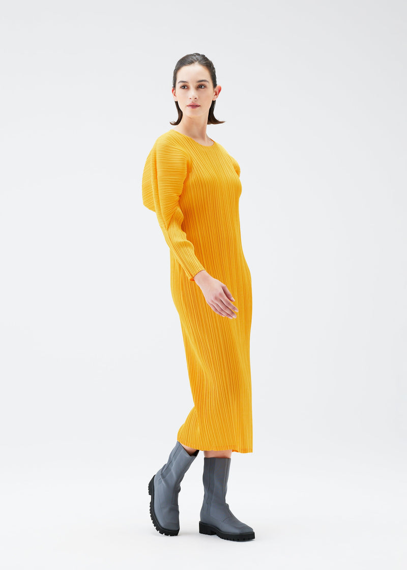 A model wears the PLEATS PLEASE ISSEY MIYAKE MONTHLY COLORS OCTOBER dress.