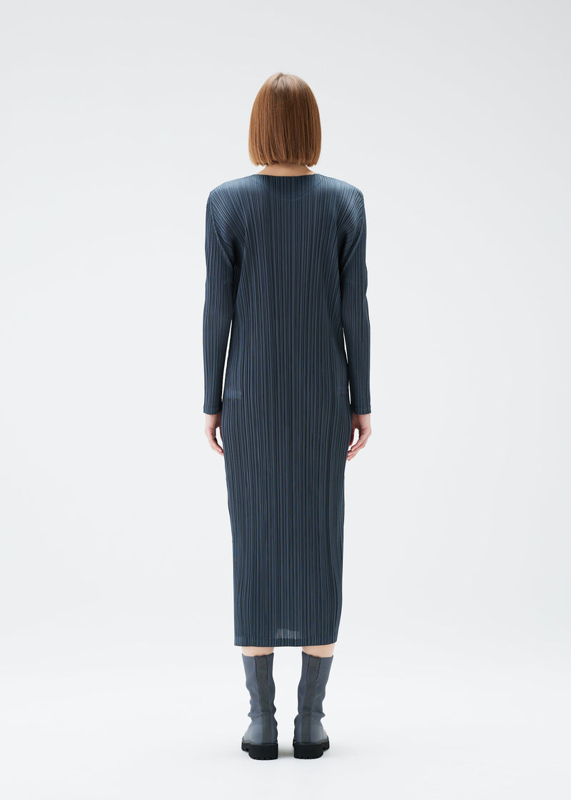 A model wears the PLEATS PLEASE ISSEY MIYAKE MONTHLY COLORS DECEMBER dress.