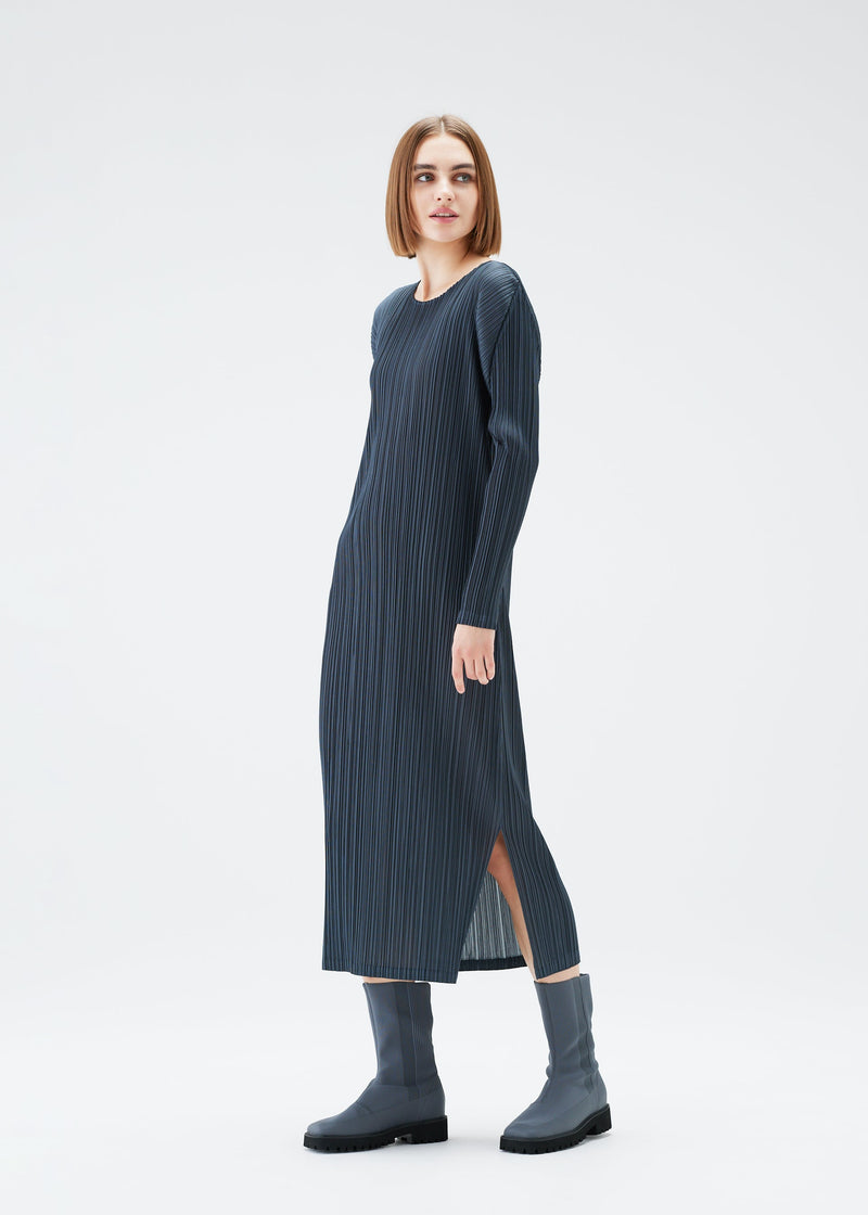 A model wears the PLEATS PLEASE ISSEY MIYAKE MONTHLY COLORS DECEMBER dress.