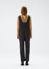 A model wears the PLEATS PLEASE ISSEY MIYAKE MONTHLY COLORS DECEMBER jumpsuit.