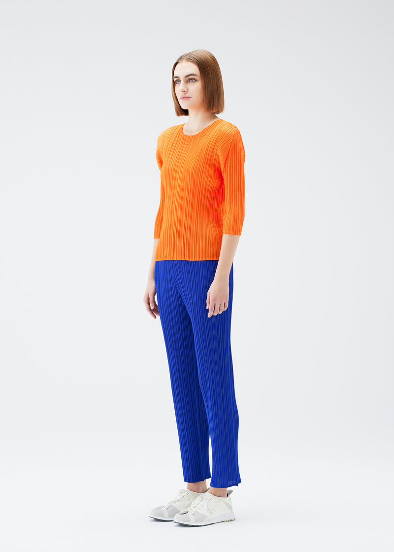 A model wears the PLEATS PLEASE ISSEY MIYAKE  MONTHLY COLORS JULY top