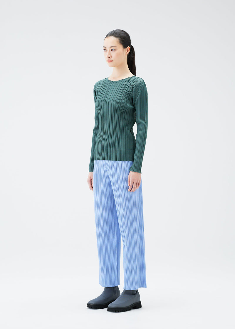 A model wears the PLEATS PLEASE ISSEY MIYAKE SOFT PLEATS top.