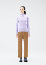 A model wears the PLEATS PLEASE ISSEY MIYAKE SOFT PLEATS top.