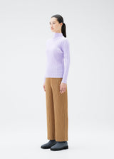 A model wears the PLEATS PLEASE ISSEY MIYAKE SOFT PLEATS top.