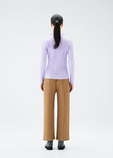 A model wears the PLEATS PLEASE ISSEY MIYAKE SOFT PLEATS top.