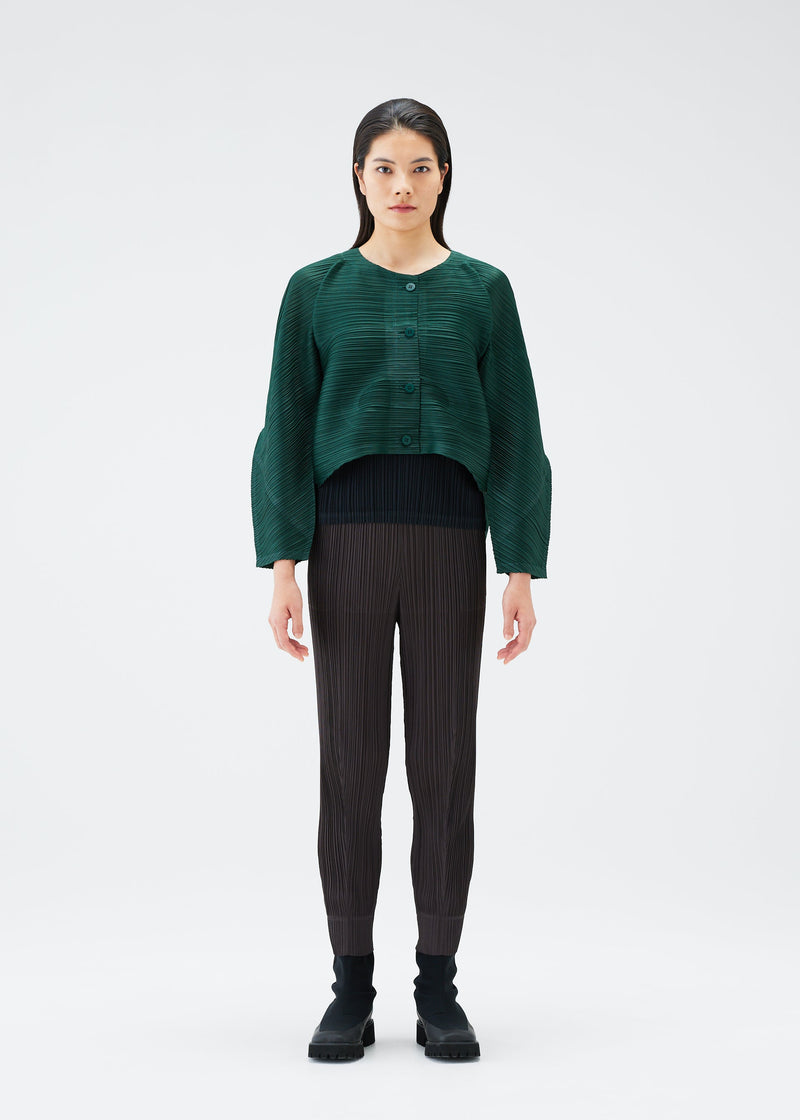 A model wears the PLEATS PLEASE ISSEY MIYAKE UFO cardigan.