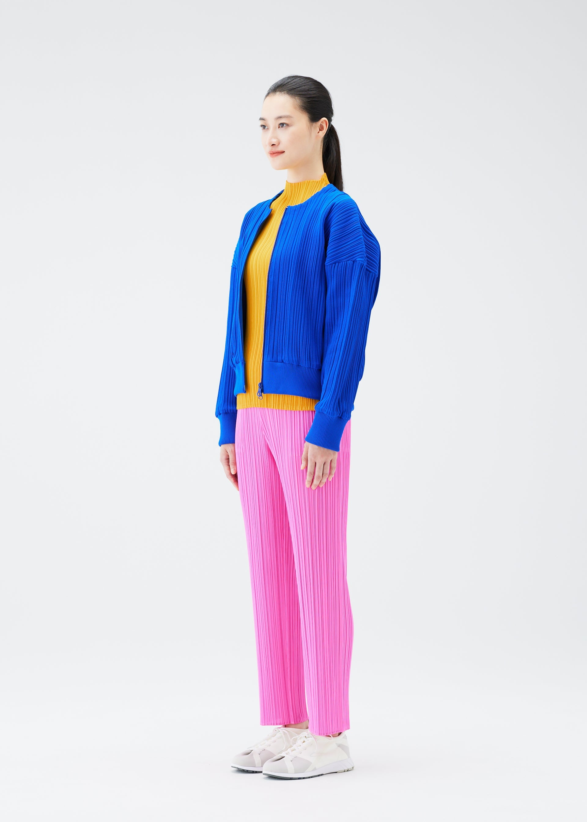 A model wears the PLEATS PLEASE ISSEY MIYAKE CREPE KNIT jacket.