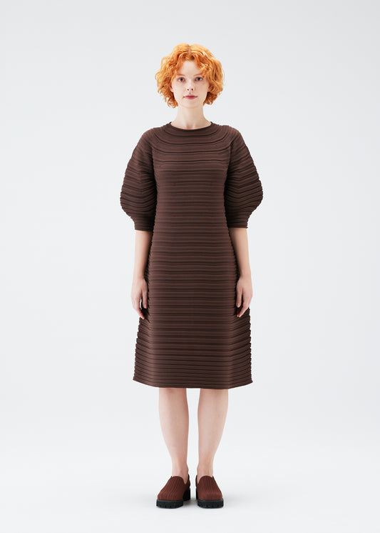 A model wears the PLEATS PLEASE ISSEY MIYAKE  MUSHROOM KNIT dress