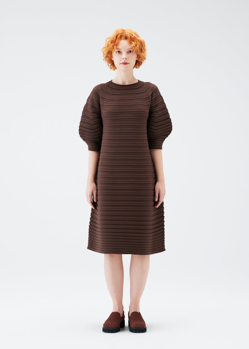 A model wears the PLEATS PLEASE ISSEY MIYAKE  MUSHROOM KNIT dress