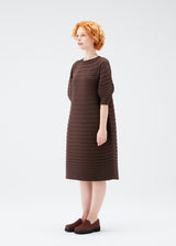 A model wears the PLEATS PLEASE ISSEY MIYAKE  MUSHROOM KNIT dress