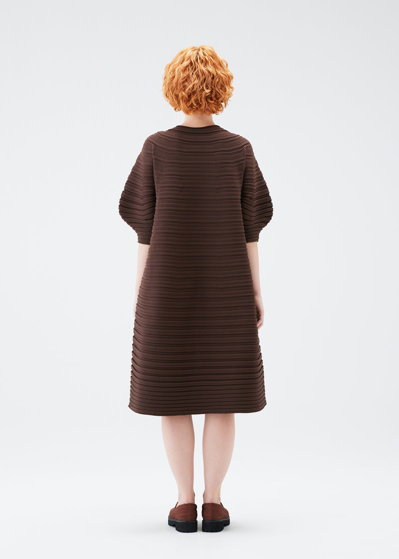 A model wears the PLEATS PLEASE ISSEY MIYAKE  MUSHROOM KNIT dress