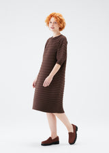 A model wears the PLEATS PLEASE ISSEY MIYAKE  MUSHROOM KNIT dress